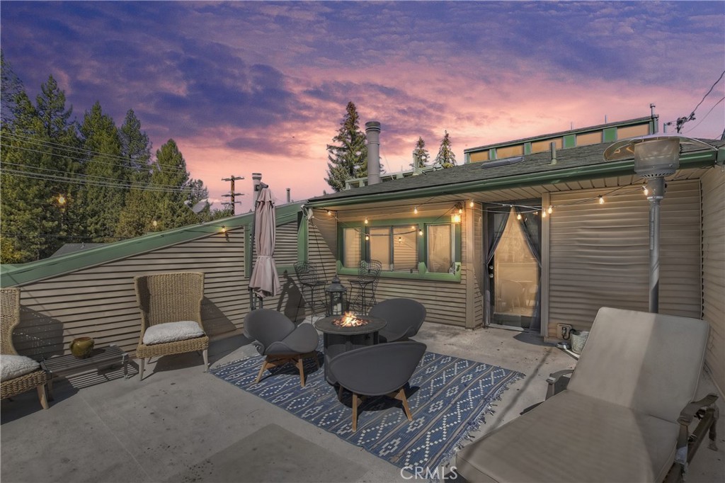 Welcome to your perfect mountain escape in the heart of Lower Moonridge ~ This beautifully updated condo is ideally situated just minutes from Bear Mountain Resort, allowing you to enjoy world-class skiing and snowboarding without the hassle of long commutes or parking challenges ~ A convenient shuttle service provides easy access to both Bear Mountain and Snow Summit, so you can hit the slopes stress-free ~ The Big Bear Alpine Zoo and the scenic nine-hole public golf course are within walking distance, making this location perfect for year-round adventure ~ During the summer months the street fair is a stone’s throw away ~ Want to grab coffee in the morning? Head to Dank Donuts just across the street or for a nightcap head to The Moonridge Room ~ The bright & open floorplan, high ceilings and expansive windows invite natural light in, creating a warm and inviting atmosphere ~ Enjoy the convenience of an efficient tankless water heater and an all-in-one washer and dryer combo unit ~ The open-concept design provides ample space for relaxation and entertaining ~ There is a two car garage to park out of the elements ~ With its unbeatable location, modern comforts, and turn-key convenience, this Moonridge condo is an incredible opportunity for a second home, or full-time residence ~ Don’t miss your chance to own a piece of Big Bear’s mountain paradise!