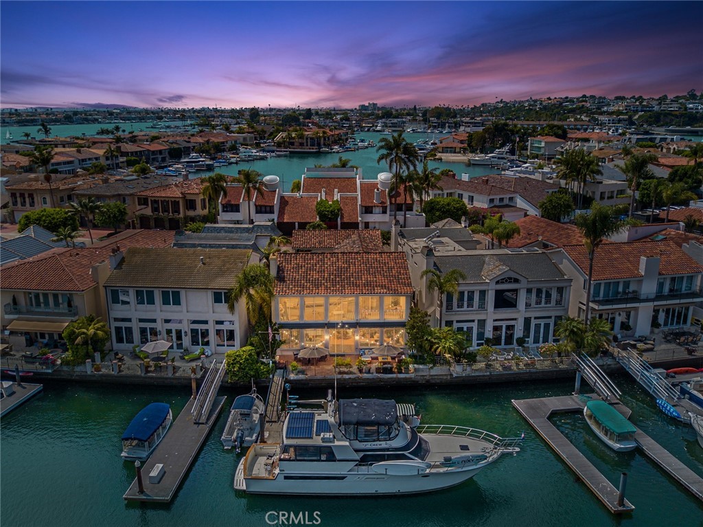 Welcome to the exclusive 24 hour guard gated community of Linda Isle. Featuring 4 bedrooms + office, 5.5 bathrooms and approximately 4,200 square feet of living space creates an extraordinary living experience on the water. Spanning 51 feet of bay frontage, the dock can accommodate a yacht approximately 60 feet in length with multiple side ties. Upon entering thru the private courtyard, the main level features a family room, dining room, kitchen, and living room with 2 story vaulted ceilings, brick fireplace, and water views. Upstairs features a large office, four nice sized bedrooms including the owner’s suite that boasts his and her bathrooms and private balcony with bay views. As a resident of Linda Isle you will enjoy amenities such as a private beach, tennis court, clubhouse, and an abundance of guest parking. Linda Isle is conveniently located near fine dining, endless beach activities, and all the entertainment Fashion Island has to offer!