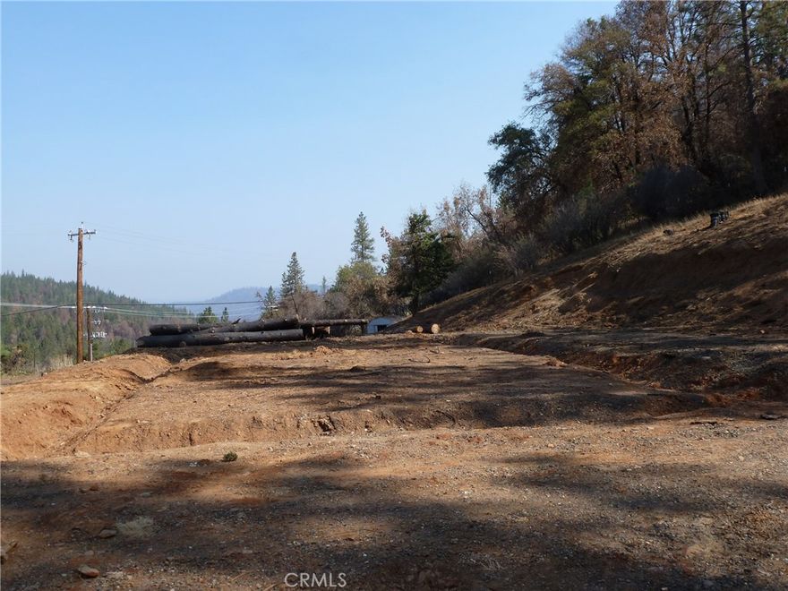 LEVELED AND READY! This 5-acre parcel in Berry Creek, has a building pad, a well, a septic, a gated driveway, AND a lovely view of the surrounding foothills. The property is only partially fenced. Property extends beyond the fence, up the hill into the trees, with most of the property being outside the fence.  There is also a well house and a chicken coop. Ready and waiting for a new owner to buy and build. Conveniently located On Oro Quincy Hwy, near Berry Creek Road, just below Bald Rock Road. Clean up from the North Complex Fire is finished. Hazardous trees have been removed and the home site leveled. Sellers have received a Certificate of Completion from Butte County.