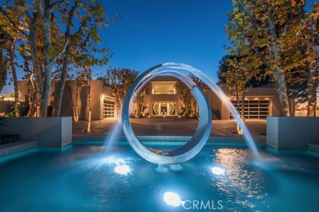 This exceptional one-of-a-kind Architectural Trophy Estate is sited at the end of a cul-de-sac in the exclusive Royal Oaks community of Encino. The walled & gated former celebrity estate sits on a 1+ acre promontory with 360 views & the utmost privacy & security. Enter to a dramatic two-story foyer with dual staircases. The living & formal dining rooms have walls of glass that create a seamless flow between the indoor & outdoor spaces. The restaurant kitchen has two center islands & professional appliances as well as an eating area. The family/media room has a fireplace, wet bar, Creston system with projector, screen & surround sound. The main level features three en-suite bedrooms. The master suite encompasses the entire second floor & includes the bedroom, luxurious bathroom, enormous walk-in closet, a sitting room w/fireplace, full exercise room, sauna, & terrace. The grounds are graced with specimen trees, lush plantings, an infinity edge pool, spa, barbecue, modern art sculptures, & expansive outdoor entertaining space. Other features include two two-car garages, downstairs & upstairs laundry rooms, & an elevator. Located in the highly acclaimed Lanai Road & Hesby Oaks school districts, a short distance to Ventura Boulevard & the Westside.