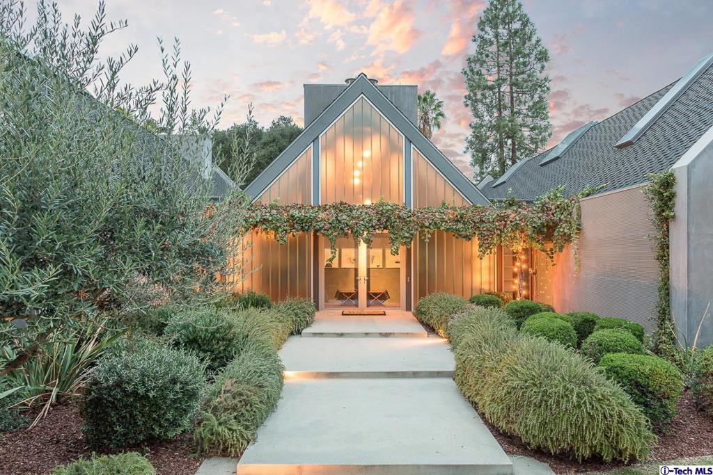 Designed for entertaining on a grand scale, this sensational contemporary smart house with its five bedrooms and six baths is situated in the sought-after Langham area. It features 12' ceilings, walls of UV structural recycled glass that disappear upon opening, and wide plank, hand-distressed walnut flooring. There are three handsome fireplaces located in the living and family rooms, as well as in the entertainer's gourmet kitchen, which also boast an oversized island with marble counter tops, state-of-the-art stainless steel appliances, doors that open to an outdoor patio and living space, as well as verdant vistas from all windows. Innovative features include an ingenious hideaway home work space with skylights, and two secret attic rooms perfect for playrooms/storage located above the bedrooms. Additionally, this dramatic architectural home offers a family/media room, powder room, separate laundry room, a direct-access finished three-car garage, and a 550 SF guest house currently being used as an exercise studio with bath and shower.
