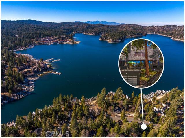 Striking First-Tier architectural with lake rights on the south shore! Sits across from lakefronts and ALA access #9. Features hardwood floors and two living areas with walls of glass that frame beautiful views of Lake Arrowhead. Master bedroom and bathroom on main level with sunken living room and linear fireplace. Upstairs, two guest bedrooms, one guest bathroom, and a loft on the second floor with a grand piano, and second linear fireplace to comfortably heat the whole of the first floor. Custom chef's kitchen with stunning Quartz island and counter tops, 5-burner double oven/range w/ griddle and convection. Custom front door & multiple outside entertaining areas. Attached two car garage. Other amenities include a three-ton mini-split A/C, Generac generator to power the complete home, LED light fixtures, fenced backyard, on a plowed and maintained road. Furnished per inventory. New bedroom, bathroom, and loft upstairs have been framed in.