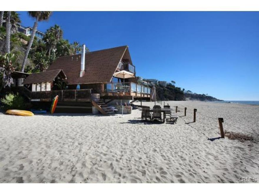A rare opportunity on the South Laguna oceanfront, this one-of-a-kind property offers two residences, private beach and endless crystal ocean, Catalina and sunset views. The over-sized lot on famed Thousand Steps Beach encompasses a beautifully upgraded bluff top cottage with over 2,700 square feet, three bedrooms, three baths and two car garage. On the sand below rests a one bedroom beach house with full kitchen, laundry, large deck, outdoor shower and unparalleled roped-off private beach area. There is a convenient funicular system to and from the beach house for ease of transport.