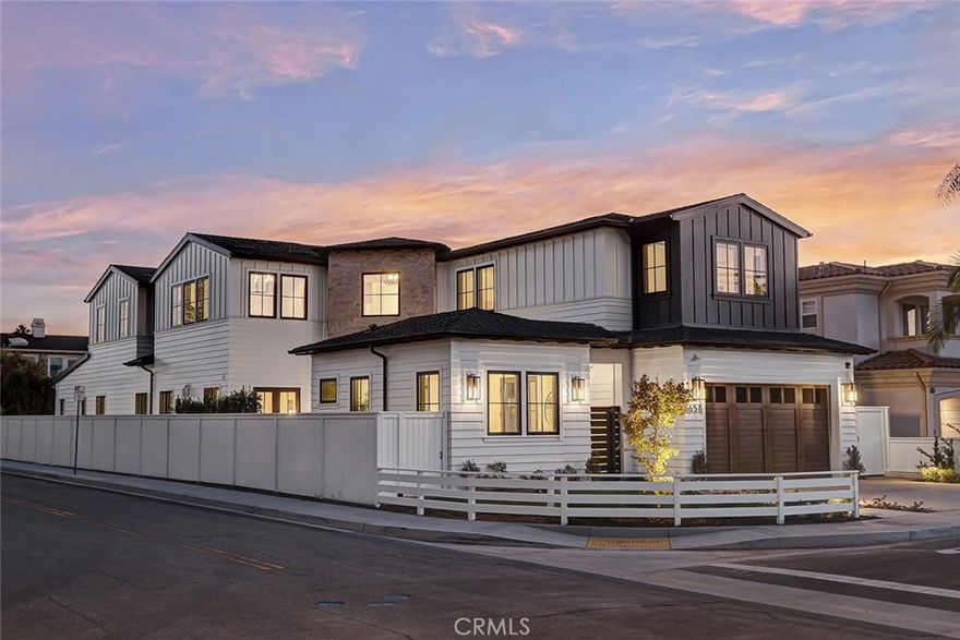 Introducing a brand-new custom masterpiece designed by local renowned Architect Mark Trotter with an interior detailed by L'Esperance Design. This stunning 4,820 sq. ft. residence is tailored for those seeking elevated living in Manhattan Beach. Set on a sweeping 7,458 sq.ft. corner lot, this home provides the ultimate balance of refined design and modern functionality, including four generous interior bedrooms and a separate, private 5th bedroom casita. Plus an expansive, upper-level bonus room that can be used as a theater, den, or converted to a 6th bedroom. With an additional 471 sq ft of outdoor covered living space and a private front courtyard, the property totals over 5,500 sq ft of combined indoor/outdoor living. Designed with the entertainer in mind, the open floor plan includes a chef’s kitchen outfitted with high-end Thermador appliances, including a 48” range and 7.5 linear ft of refrigeration. Rift-cut white oak cabinetry, non-staining Porcelain Taj Mahal slab countertops, and dual full-size Juliene farm sinks enhance the aesthetic and utility of the space. The butler's pantry, dry bar, and a 58-bottle Thermador wine cooler make this kitchen as ideal for hosting gatherings as it is for daily living. The spacious great room invites relaxation with a marble-faced fireplace, expansive 100” TV, and an entire wall of panoramic doors that opens up to a landscaped, pool-sized backyard. Enjoy outdoor entertaining under a covered patio centered around an outdoor fireplace. The home is wired for a Control4 home automation system with 12 zones of music, app-controlled thermostats, security cameras, and an alarm system. Prewired for future amenities that can be managed via a sleek wall-mounted iPort plus three Control4 keypads. The primary suite offers a private sanctuary with vaulted trey ceilings and ambient lighting, a stone-faced fireplace, a private balcony that overlooks the backyard, and a custom walk-in closet complete with a dressing island and LED lighting accents. The primary bath exudes elegance with a designer soaking tub, a spacious walk-in shower with multiple heads, and LED-lit mirrors. Additional features include a large elevator, reclaimed barn wood beams, wide plank white oak flooring, and energy efficiencies such as solar panels and pre-wiring for future EV chargers in the three-car garage. This home is both luxurious and eco-friendly, designed to meet the needs of today’s discerning homeowner.