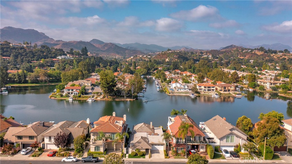 This luxurious single story is situated on the main channel within the prestigious Gated community of Westlake Island, an oasis of beauty and sophistication nestled in the heart of Westlake Village. Stepping into the home you are greeted with an abundance of natural light that floods every corner. This home offers comfortable living spaces that seamlessly integrate with the amazing outdoor entertaining areas creating the ultimate California indoor/outdoor lifestyle home. The kitchen provides stainless steel appliances with custom cabinetry opening to the dining area. The primary bedroom is equally impressive, with picturesque windows that showcase stunning lake & mountains views. The oversize spa like master bath boasts an abundance of closet and storage space. The secondary bedrooms are oversized with plenty of closet space. Walk out to your dock just steps from your patio and enjoy a sunset cruise or dinner at the landing or Boccaccio's on the water. 24 hour guard gated community on the island & conveniently located to all.