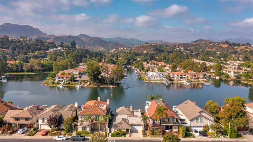This luxurious single story is situated on the main channel within the prestigious Gated community of Westlake Island, an oasis of beauty and sophistication nestled in the heart of Westlake Village. Stepping into the home you are greeted with an abundance of natural light that floods every corner. This home offers comfortable living spaces that seamlessly integrate with the amazing outdoor entertaining areas creating the ultimate California indoor/outdoor lifestyle home. The kitchen provides stainless steel appliances with custom cabinetry opening to the dining area. The primary bedroom is equally impressive, with picturesque windows that showcase stunning lake & mountains views. The oversize spa like master bath boasts an abundance of closet and storage space. The secondary bedrooms are oversized with plenty of closet space. Walk out to your dock just steps from your patio and enjoy a sunset cruise or dinner at the landing or Boccaccio's on the water. 24 hour guard gated community on the island & conveniently located to all.