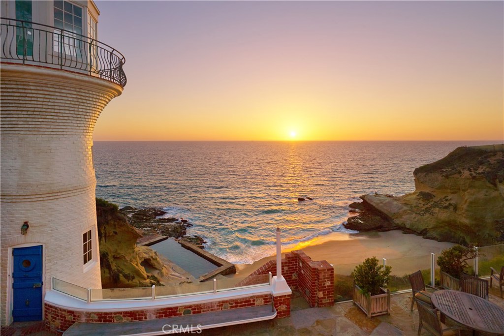 ABSOLUTE AUCTION, WITHOUT RESERVE by DeCaro Auctions International. Breathtaking panoramic ocean views surround this rare beachfront estate in the exclusive seaside community of Three Arch Bay. Gracefully situated above a private cove and completely immersed in nature, the magnificent setting includes cobblestone paths that wind through the grounds, an oceanfront terrace spanning the width of the property, and an awe-inspiring lighthouse complete with viewing room and bathroom. Built by Edward H. Griffith, a famous director and producer in early American filmmaking, this historically significant residential compound remains a treasured landmark along the Laguna Beach coastline. In addition to the property’s celebrated lighthouse, the compound encompasses three separate living structures; two guest cottages and a nautical-style main house with reclaimed finishes including custom millwork, cage elevator, porthole windows, and a ship’s staircase. Private steps lead down to the sand which make this an incredible opportunity to own a residence with endless possibilities in a setting of unrivaled beauty.
