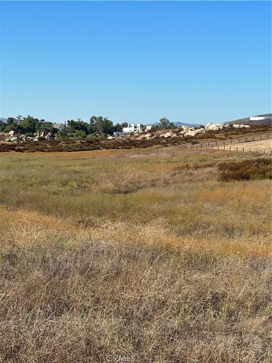 Gentle rolling 5.03 acres located 2 lots from paved Auld Road, and 3 lots away from paved Pourroy Road where all the tract homes are. Utilities in Mazoe Street. Perfect for custom/Manufactured home with room for horses. See environmental constraint sheet for flood plain on southwest corner of property.