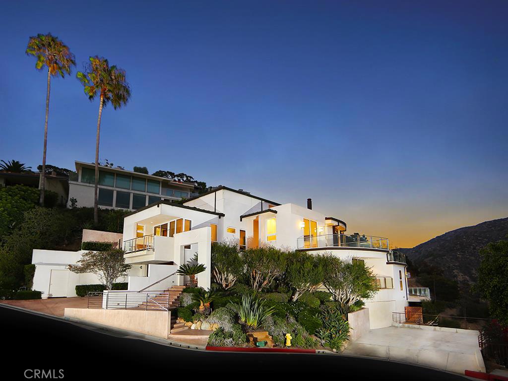 Congruent clean lines and modern design abound in this striking 6,000 sq. ft. home in Emerald Bay. Situated on a rare corner and double lot, the house offers over 2,000 sq. ft. of outdoor deck space, including an infinity spa and breathtaking water views. Inside the home features 5 bedrooms and 7 baths, and is filled with the finest finishes and ultra-sleek architectural elements. The gourmet kitchen is spacious and open, making it the perfect space to prepare intimate family meals or for entertaining guests and hosting large parties. This multi-level house showcases panoramic views of the Pacific from almost every space within. Emerald Bay offers privacy, security and luxury, just steps from the sand and the best in shopping and outdoor life of Laguna Beach and Newport Coast combined. The master bedroom and bath feel like a five-star resort, with serene balcony vistas, massive his and her walk-in closets, and a spa style en suite. Its both sumptuous and minimalist at once. The house offers a large two car garage, an extended driveway and additional parking spaces on the approximately 12,000 sq. ft. lot. This home is the definition of refined and understated elegance, situated in a perfect location in the heart of Orange County’s coastal community.