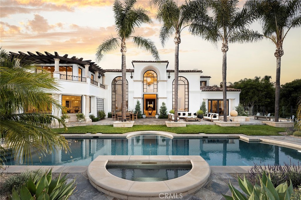 Perched behind its private gates, the Fair Harbor Estate, atop a prime wraparound lot in Pelican Hill, boasts sweeping ocean, Catalina Island and golf course views from every level of its Montecito-inspired design. The property was recently reimagined, completed 2022, with an assortment of sophisticated design elements including Calacatta Soft Gold and Greek Thassos marble, honed stone flooring, custom millwork and built-ins, limestone fabricated fireplace, and Rohl polished nickel fixtures throughout. The home’s beautiful interiors and open floorplan are a refreshing and refined aesthetic rarely available in the community. The property includes five en suite bedrooms, seven bathrooms, a formal entertainer’s room and bar with soaring ceilings, great room and gourmet kitchen with Thermador & Sub-Zero appliances, his-and-her office, media room, and home gym. The expansive primary suite is comprised of a sitting room with expansive ocean views, marble slab shower, soaking tub, sauna and walk-in closet. In addition to the privately gated driveway, there are two garages, each large enough for 2-cars and some. The grounds, spanning half an acre, feature a sizable pool and spa, built-in barbecue and dining area, lookout point, and large enclosed grass yard.
Pelican Hill is a prestigious gated community above Pelican Hill Resort in Newport Coast. Home ownership includes two private security gates, roaming 24-hour security, and access to the Newport Coast Community Association clubhouse, pool, playground and tennis courts. Residents additionally enjoy close proximity to the shops and restaurants at Crystal Cove, Crystal Cove State Beach, and Fashion Island.