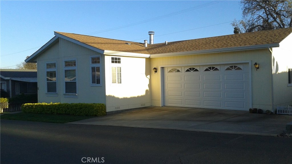 Beautiful extra large dbl wide manufacture home on perm. foundation with an attached two car garage. Home was brought into the park from the previous owner and he spared no expense on this home that is going to benefit the new owner. One of the bedrooms was turned into an office with a built in sink with mini fridge and sliding door out to your private covered deck. Master bdrm is extra large and has a walk in closet with an extra space for storage and be sure and ask agent on this extra space. Master bath is extra large with a deep bath with jets and a double shower with handicap bars for extra support. Well manicured yard and easy maintenance. Formal dinning room off kitchen. Fireplace in living room. Home theater in second bedroom. Separate laundry room opens into garage. A must see for this rare opportunity in a desired senior park on the lake side.