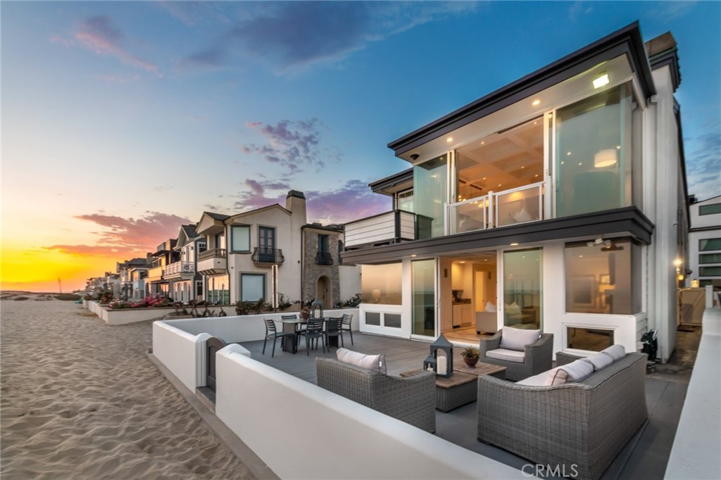 This extraordinary rare corner oceanfront location offers magnificent, unobstructed “sit-down” panoramic ocean views from all levels with a stunning backdrop of golden sunsets year round, Catalina Island and crashing surf. Uniquely offering 5 bedrooms and 5 full bathrooms to comfortably accommodate large families and their guests in addition to parking for 4 cars! Enjoy entertaining and timeless memories with the finest beachfront lifestyle located right outside your back door. Outdoor living at its finest with a large oceanfront patio for alfresco dining plus decks off the mid and upper levels providing breathtaking 180 degree views of the coastline. The exterior offers timeless coastal architecture with new paint and glass panes in windows. The light and bright open and flowing interior with voluminous ceilings and 10 skylights throughout was recently painted in a clean, white palette including cabinetry to showcase a coastal beach-vibe. The main level features a an inviting entry foyer, guest suite with full bathroom, family room with built-ins, coffered ceiling, fireplace, wet bar and private office with inspiring views of the blue Pacific. Ascend the curved staircase with towering skylight to the main living level that showcases breathtaking views, an open Chef's kitchen with abundant natural light including breakfast bar, granite counters, 48” Sub Zero refrigerator, Bosch dishwasher, custom built-ins, fireplace, refinished deck for morning coffee and a formal dining room with ocean views. Down the hall you’ll find 3 spacious guest suites all with vaulted ceilings and one with an en-suite bath. The upper level is exclusively the private master suite with vaulted ceilings, roof top deck, a spacious bathroom with dual sinks, jetted spa tub and walk-in closet. For those desiring to minimize stairs, the home is elevator ready and was designed into the original plans for ease of implementation and access to all levels. Other features include dual central A/C (newer), separate laundry room, custom lighting, security system w/ cameras, 2 car single car garages with storage, epoxy floors and off street parking for 2 additional cars. The tax records show the original home was built in 1958 but the home was completely re-built and renovated down to the studs in 1998. Easy access from PCH and to restaurants located across the street. Simply the finest location in West Newport for those searching to find the best views and luxury beach lifestyle. Surf’s up!