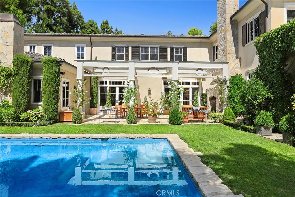 This custom home, located in the exclusive community of Big Canyon, combines French Provencal charm with modern luxury. The craftsmanship is exquisite, with carefully planned built-ins and the finest millwork. The formal living room features a cozy fireplace, hand scraped open beamed ceiling, and adjacent library/billiard room. The great room and kitchen area are a dream with an ample marble island, Wolf and Sub Zero appliances. The Kitchen connects to a butler's pantry, homemaker's office, mudroom, laundry room, and maid's quarters. The sprawling master wing is beautifully designed. It is complimented by a sunny veranda, office, his and hers walk-in closets, and exercise room. The master bath is delightful, with its free standing tub, large shower, and glistening Carrara marble floors and counters. There are three additional bedrooms and a secondary family room on the second floor. The landscaping is meticulous and highlights an elegant pool and spa, outdoor fireplace, fire pit, dining areas, and a well appointed outdoor kitchen. This private estate is on a large lot on a beautiful tree-lined, cul-de-sac street.