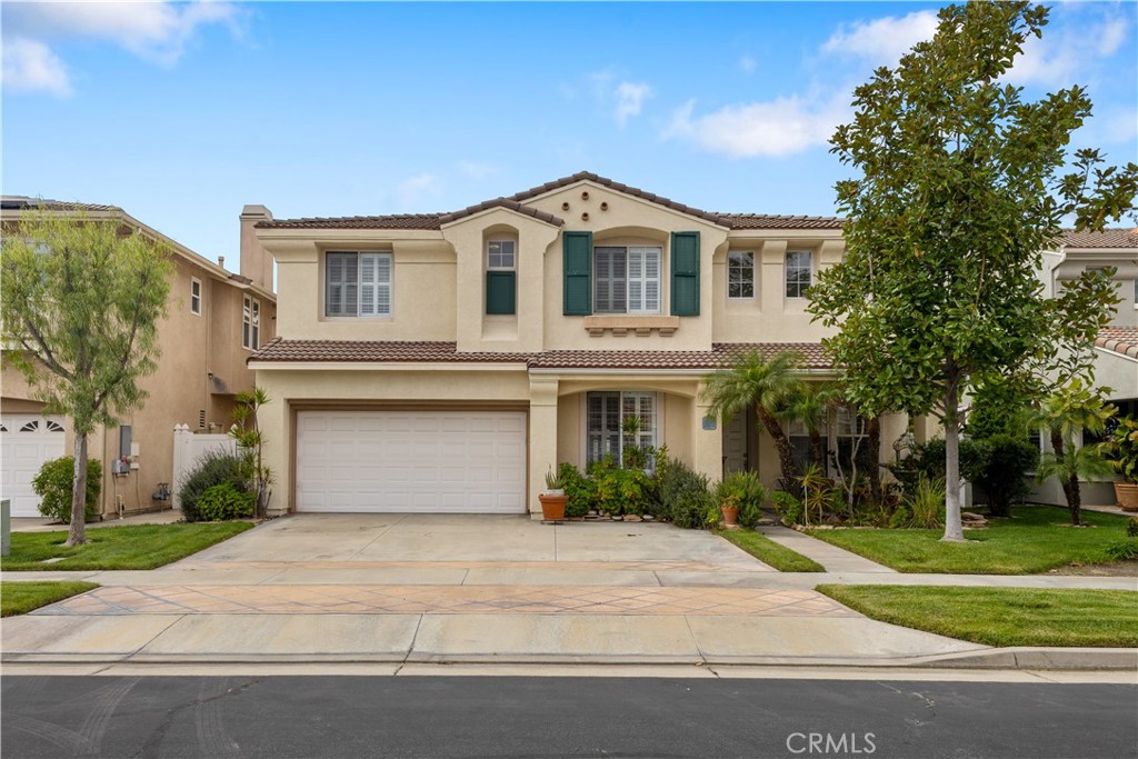 Your home will truly be your castle with this spacious, sunny estate located in the exclusive gated community of College Park! Welcome to 9009 Harvard Avenue, a gorgeous property you must see to believe. With 3,150 sq ft, 5 bedrooms, 3 bathrooms, a bonus library/office, this is all you could need or want in a home! Elegance abounds with rich maple flooring and classy plantation shutters accenting throughout. From your first step, you'll love the formal living room with its soaring cathedral ceilings. Beautifully open floor plan leads to a well-appointed kitchen with warm, natural wood cabinets, seemingly endless counter space and bar top, a convenient kitchen island, sleek Bosch refrigerator, gourmet Viking stainless stove and two separate dining areas. Entertainment and relaxation will be easy in adjoining family room with its cozy gas fireplace. Upstairs, an impressive primary bedroom entices with its elegant, wood flooring, grand size, and walk-in closet. Ensuite bath has separate soaking tub, walk in shower, and two separate vanities! There are 3 additional, sun-filled bedrooms on this level, each sizable, with ample storage. Working from home? You'll love the beautiful and open library/office and its rich, natural wood cabinets, built in bookshelves and desk. It's the perfect setup! Full laundry room, including high end Miele washer and dryer, completes the upper level. Outside, you'll find a low maintenance, drought friendly backyard, with a large patio area, and flanked by privacy providing vinyl fence. Two car attached garage has a super clean epoxy floor and whole house water filtration system. Low cost HOA adds wonderful amenities including pool, spa, playground, and picnic area. Centrally located, close to restaurants and shopping, just minutes from the 91, the 5, and Knotts Berry Farm: It's all right here!
