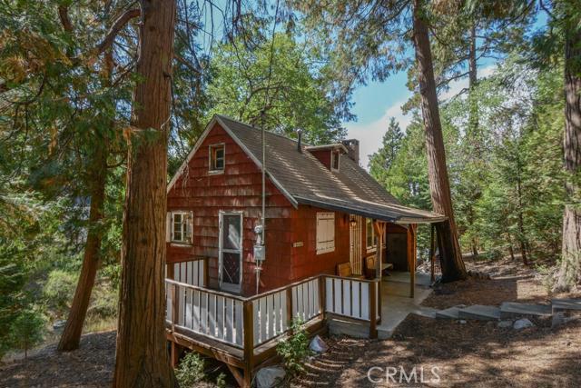 Who is ready for a rehab? Check out this circa 1936 vintage charmer on an oversized 8,000 + sq ft lot!...Enter into the main level with the living room, brick fireplace, tongue & groove paneling & updated flooring. There is also access to attic space above the living room that could be turned into more living space or opened up for vaulted ceilings. Also on the main level is the kitchen, bathroom & stairs down to the two bedrooms. This quaint little cabin is walking distance to town with shopping & restaurants. Also close to the off road trails & Deep Creek. There is a lot of potential just waiting for the right buyer!