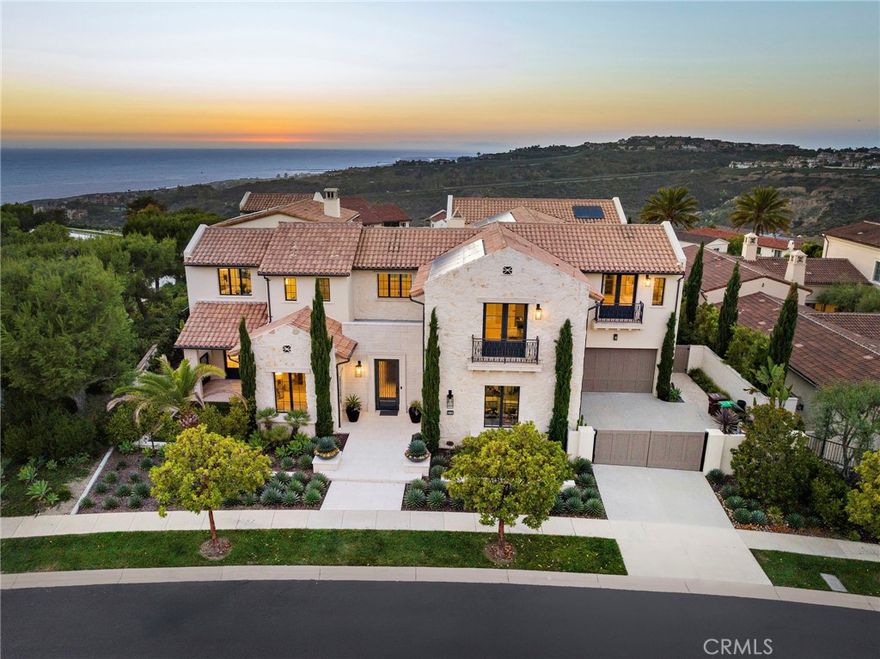 Introducing a rare gem in the Crystal Cove community, where contemporary luxury meets the majestic beauty of California’s coastline. This extraordinary estate, spanning 8,870 +/- square feet, plus an enclosed heated loggia of 500 square feet, situated on an oversized secluded and private corner lot, with unparalleled ocean vistas and sophisticated design and privacy. Surrounding a beautiful central courtyard, the home’s architectural brilliance is highlighted by expansive La Cantina doors that effortlessly merge the indoors with the outdoors. The heart of this luxurious estate is its magnificent entertainer’s kitchen and dining room, with its serene views of a beautifully landscaped central courtyard. Featuring two large islands, state-of-the-art appliances, and a separate caterer’s kitchen – this culinary haven is designed for both grand entertaining and intimate gatherings highlighted by a distinctive glass-encased, climate-controlled wine room for 936 bottles. The adjacent great room and California room offer an inviting atmosphere for socializing and savoring the panoramic ocean views. The primary suite is a sanctuary of luxury, boasting expansive ocean views and two en-suite bathrooms and dual walk-in closets. This private retreat offers an escape, where every detail has been crafted for ultimate comfort and relaxation. With seven generous bedrooms and eleven exquisitely appointed bathrooms, this estate is ideal for multi-generational living, with a guest wing connected to the main part of the home featuring a main floor junior primary suite with direct pool access, sitting room and kitchenette and additional guest suite, while on the second floor there is a bonus room and open-air terrace with an additional two-room suite, ensuring ample space and privacy for family and guests alike. Outdoors, the residence features a gated motor court (plus garaging for four vehicles), and an infinity pool that appears to merge with the horizon, creating a serene spot for relaxation. The central courtyard, a centerpiece of the home’s design, enhances the connection between indoor and outdoor spaces. This exceptional property is in a community that offers 24-hour guard-gated security, private access to The Canyon Club and its recreation and sports facilities, walking-distance private access to Crystal Cove State Park and beaches, as well as proximity to world-class shopping, dining, and entertainment in Newport Beach and the Laguna village.
