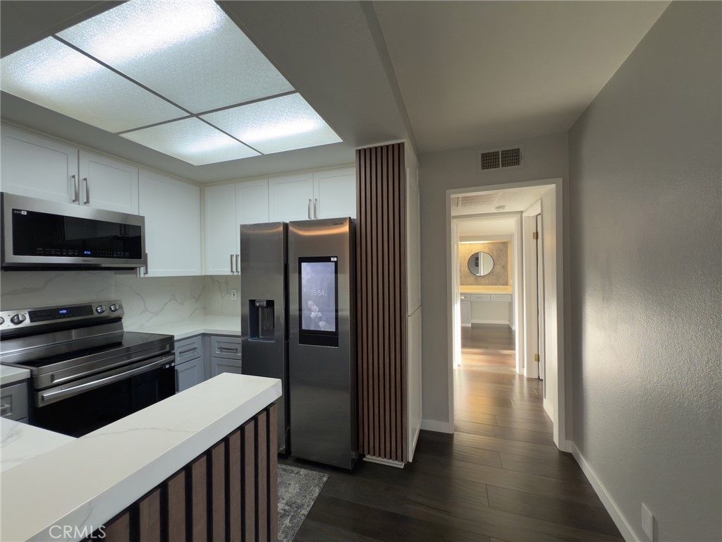 $50K reductions for a quick sale! Absolutely amazing dream condo in the Desirable “Warner West” Community! This exceptional condo, located in the heart of the highly sought-after Warner West community, offers a rare and desirable floor plan. With contemporary design elements throughout, this home shows like a model! Tastefully upgraded, it features a beautifully designed kitchen with sleek quartz countertops, newer modern stainless steel appliances that are both Wi-Fi and voice-enabled, an extra-large barn sink, custom soft-close cabinet doors and drawers. The luxury laminate flooring throughout adds a touch of elegance, while energy-efficient LED lights illuminate the space. Smart switches are installed in the living room, kitchen, hallway, and bathroom for added convenience. The Nest-controlled central heating and air system ensures year-round comfort, while brand-new electrical outlets and light fixtures have been installed. Freshly painted walls, bath, doors, and balcony enhance the overall appeal. Step outside to enjoy the spacious L-shaped balcony with a tranquil pool view—perfect for relaxation. The property includes two dedicated parking spaces.Community Amenities include a Fitness center, Spa, Pool, Basketball court, Recreation room for gathering, ample guest parking. The HOA covers water, sewer, trash, earthquake insurance, and more. Ideally located near Topanga Village, Warner Center Park, Trader Joe’s, Whole Foods, Amazon Fresh, Costco, and fine dining. Public transportation and easy access to the 101 Freeway make commuting a breeze.