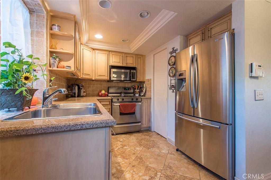 Rarely on the market this 3 bedroom 2 bathroom condominium has lots to offer. Conveniently located to Choc and St. Joseph's hospital as well as the 22/57/5 freeways. The kitchen has been updated with granite counter tops, newer cabinets and appliances, large pantry and stone floors. There is a half bathroom downstairs and lots of storage. All the bedrooms are upstairs and the master bedroom has mirrored closet doors, bathroom attached and balcony. Both bathrooms upstairs have been updated with newer cabinets, granite counter tops and there is a stone shower and a walk in tub. The unit has a nice sized patio with a yard for plants and entertaining and a mature lemon tree. There is a one car garage attached to the patio and a laundry closet that is for the washer, dryer and water heater. The complex has a well maintained pool and picnic area.