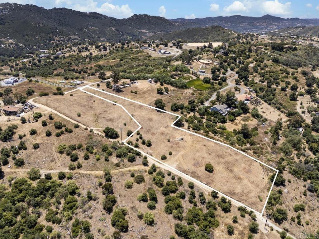 Great opportunity to own 2.68 acres with gorgeous views in Valley Center. This parcel is situated on a serene hill that overlooks Palomar Mountain and the nearby foothills. This parcel allows for the construction of one custom home, + 1 ADU offering the perfect site to create your dream residence. The versatile land use is ideal for a variety of agricultural pursuits, including fruits, vegetables, flowers, and animals (subject to county regulations). 1-inch water meter has already been assigned and paid for - the only remaining cost is $700-$1,000 for backflow device. The well has not been used in many years, but prior production was between 10GPM - 15GPM. Fire Hydrant and overhead electric are both nearby. Per the Parcel Map, there is a Health Department Certificate for a 4 bdrm septic approval. Conveniently located near Woods Valley Rd with easy access to Escondido and Bear Valley Pkwy. With close proximity to Lake Wohlford, parks with trails, and minutes away from major freeways. A short drive to the beaches makes it easy to enjoy coastal activities. This is an exceptional opportunity to invest in a developing area with endless possibilities for custom homes and agricultural ventures. Don't miss out on the chance to own this prime piece of land in Valley Center! **The adjacent 2.3 acre parcel is also listed for sale - 15642 Mathew Rd.**