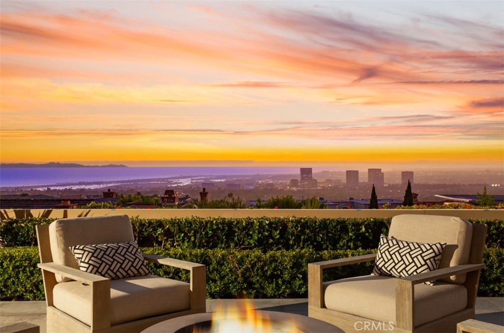 One of the finest ocean view custom estates to be offered in Newport Beach, 9 Crestwood is championed behind the exclusive guard gates of Harbor Ridge. Ideally situated to optimize the unparalleled views of the Pacific Ocean, Catalina Island, Fashion Island and up to LA, nearly every room in the home enjoys this glorious scenery. Recently remodeled from the foundation up, the home offers approximately 7,300 sqft of transitional, bright living space, made possible by an abundance of natural light throughout. The main level delivers a magnificent first impression as you enter custom steel and glass entry doors with soaring ceilings, a spacious executive office with fireplace is off to the left and direct ocean, harbor and city lights views are directly in front of you. A gourmet chef’s kitchen, highlighted by a sizable island, pro-grade appliances, & custom milled cabinetry, open to the family/great room, which is complemented by wood beamed ceilings, limestone flooring with bi-folding doors along the back of the home weaving the indoor & outdoor spaces into one, providing ample space for lavish celebrations while maintaining warmth and practicality for everyday living. The grand owner's suite boasts a bathroom wrapped in luxurious marble featuring spa like amenities .The 4 additional guest suites grace the second floor. The lower level offers a media/game-room and additional flex space. Immediate proximity to world class schools, dining, and shopping complete this dream home.