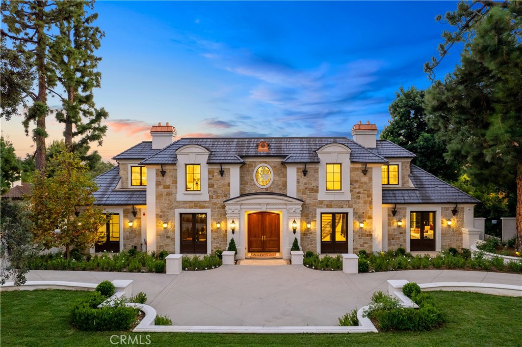 Magnificent Arcadia estate in the highly sought-after Upper Rancho neighborhood designed by the reputable Robert Tong of Sanyao Intl. Newly constructed, this French Country-style mansion features 6 bedrooms, 6.5 baths, and multiple entertainment areas over 9,500 sqft of unparalleled grandeur. Impeccably landscaped grounds greet you as you drive past the gates, elevating this abode’s exceptional curb appeal. Through the impressive double doors, discover an equally stunning interior displaying the finest finishes with excellent attention to detail; from the two-story foyer’s grand artisan staircase and soaring ceilings to the exquisite millwork and gleaming marble flooring, there’s a lot to love. Serve refreshments in the sun-soaked living room, adorned with expansive floor-to-ceiling picture windows and a stately fireplace that radiates warmth in chilly seasons. Designer wallpapers, elegant wainscoting, and opulent chandeliers enhance the dining room’s refined atmosphere as you hold intimate celebrations. Afterward, cleanse your palate with nightcaps in the glass-enclosed wine room alongside a marble-clad wet bar that adds an air of sophistication. Straight out of a magazine, the chef’s kitchen beckons with top-of-the-line appliances, gorgeous cabinetry, eye-catching backsplash, and sleek quartz countertops that flow to the multi-seater island. A fully equipped butler’s pantry, a separate prep kitchen, and a scenic breakfast nook complete this delightful culinary space. Double doors reveal a generous primary suite that defines luxury with its window-side sitting area, boutique-like closet, and an unmatched 5-piece bath with an oversized frameless shower and a spa-like soaking tub. Fun and recreation are endless with this home’s state-of-the-art movie theatre, versatile loft with its own wet bar, and a gym with a sauna. Enjoy working remotely or meeting clients within an executive private office that’s elevated with finely crafted cabinetry, stylized ceilings, and picturesque views. Resort-inspired yard, surrounded by towering mature trees, vivid blooms, and verdant hedges. With a built-in BBQ, multiple seating options, and a manicured lawn centered around a pristine pool and spa, every day feels like a vacation. Notable inclusions are a laundry room and attached 4-car garage. Plus, this gem is located within the prestigious North Arcadia School District, ensuring quality education, Come take a tour of this spectacular haven while it’s still available!
