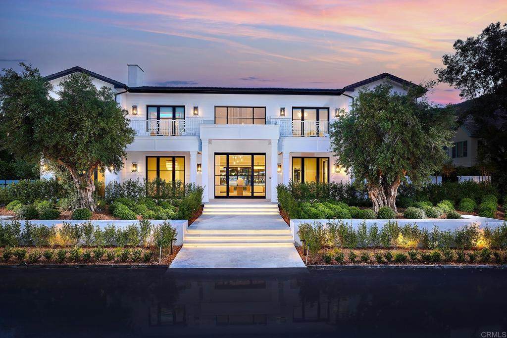 This stunning modern masterpiece is a true paradise for those who appreciate the finer things in life. Located within the exclusive Del Mar Country Club, this fully remodeled, gated, custom luxury estate boasts premium designer finishes and meticulous attention to detail throughout. As you approach this exquisite home, you are greeted by gorgeous greenery, a stunning steel entry pivot door, grand foyer with soaring ceilings and perfectly paneled walls, anchored by the formal dining room with wine cellar and formal living room, both drenched in natural light. The expansive great room impresses with vanishing pocket doors offering picturesque views of the lushly landscaped yard. 2 breathtaking Jonathan Browning Marignan crystal glass chandeliers are not only a focal point, but emit glistening light that serves as the perfect backdrop to showcase your most cherished possessions. The sleek linear fireplace creates the perfect ambiance in any season. Throughout the home you will be awed by the architecture and beauty, coupled with the appealing and accommodating open floor plan. The outdoor living areas were designed as an extension of the indoor living areas with over 10,000 sq ft. of combined usable space. The great room seamlessly extends into the open concept gourmet kitchen that is worthy of a chef's kiss with numerous Miele ovens, warming drawers, 2 large waterfall center islands, 2 sinks, 60" Officine Gullo Fiorentina professional multi-function touch screen oven, range, hood and storage galore. Virtually every room in this estate offers either a golf course view or a glimpse of your backyard bliss. This home has undergone a complete top to bottom remodel, making it essentially brand-new construction and feel as if it has never been occupied before. The 5-star resort-like amenities of this home are unparalleled, providing the ultimate in luxury living. Every detail of this home has been carefully crafted to provide the perfect blend of sophistication and comfort, creating a truly unforgettable living experience. The home is equipped with Lutron Smart Technology, whole home Savant automation that controls audio, video, lighting, cameras and network, a temperature-controlled wine cellar adjacent to the dining room, solar with battery, home security system, interior and exterior speakers throughout and EV outlet in garage. This property is appointed with five generously sized ensuite bedrooms, including a luxurious primary suite with fireplace, sitting area and balcony overlooking the golf course. The opulent primary bath with walk-in shower, soaking tub and dual vanities, leads to a massive walk-in custom closet that will make you feel like you've entered a high-end boutique. Experience the ultimate in outdoor living as you bask in the beauty and serenity of this stunning outdoor oasis ideal for entertaining. Whether you're looking to relax in the serene pool and spa surrounded by snow white quartzite, entertain guests in the outdoor kitchen complete with leathered granite countertops and BBQ, cozy up by the Lumacast fire pit or enjoy some vino and views from one of the multiple balconies, this estate has it all. Alongside these amenities, you can marvel over the mature olive trees direct from a Napa Valley orchard and the LED lighting under each stair tread that exudes ambient luminescence. Del Mar Country Club offers a luxurious lifestyle that combines sophistication and exclusivity, with the added convenience to golf, beaches, shopping, equestrian facilities, sought after school districts, tennis and more.