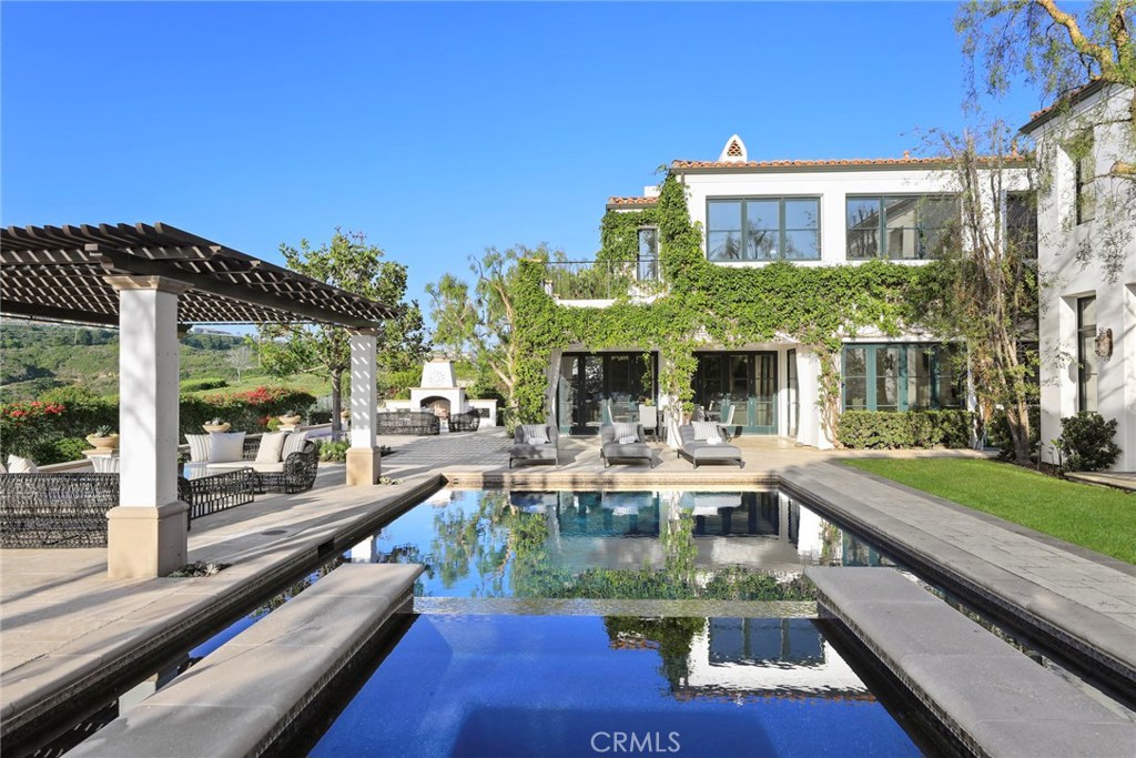 Recently refreshed and situated on an ultra-private, over 25,000 +/- square foot lot in the prestigious community of Pelican Hill, this Santa Barbara style estate offers breathtaking canyon, harbor and city lights views. 25 Canyon Terrace showcases a level of quality & detail beyond compare. The dramatic foyer features two-story ceilings and a formal living room, complete with a spectacular wood burning fireplace and abundant natural light. Social rooms are adorned with hardwood and stone floors, and are accentuated with beautiful light fixtures. The gourmet kitchen graciously extends to the family room, which showcases gorgeous, solid wood built-ins. French doors open to the well-appointed rear yard with pool and spa, outdoor fireplace and numerous sitting areas. The luxurious master suite offers a walk-in closet, spa style bath and fireplace with a private terrace opening to the views. Your guests will feel at home in the detached guest house with kitchenette and doors opening to a private patio. Experience the famed Pelican Hill Resort and Golf Course, world class Newport Coast lifestyle with close proximity to beaches of Crystal Cove State Park, shopping and dining at Fashion Island, and John Wayne Airport and LAX.