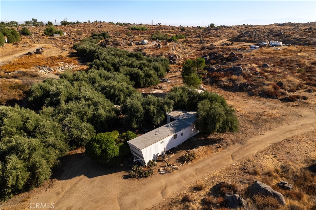 This property is 2.5 acres of land with a mobile home on it. The mobile home receives water from a separate property; however, water is NOT included with the purchase of this property. The mobile home has an attached septic system. The mobile was built in 1969, is over 384 square feet and has two bedrooms and one bathroom, along with a kitchen and living room space. This property offers rural living, opportunities for building and developing, and plenty of space to bring your vision to fruition. This is one of four properties being offered and can be purchased individually, or along with any of the other three properties if desired. For reference: the additional property addresses are:
26874 Wilkinson (water supply), 26845 Tooker and 0 Tooker. Appointment required to visit this property.