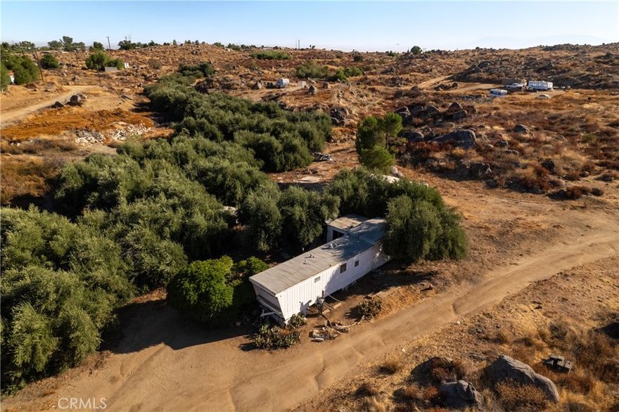 This property is 2.5 acres of land with a mobile home on it.  A water source is NOT included with the purchase of this property, current water supply comes from the well at 26874 Wilkinson.  The mobile home has an attached septic system.  The mobile was built in 1969, is  over 384 square feet and has two bedrooms and one bathroom, along with a kitchen and living room space.  This property offers rural living, opportunities for building and developing, and plenty of space to bring your vision to fruition.  This is one of four properties being offered and can be purchased individually, or along with any of the other three properties if desired.  For reference: the additional property addresses are:
26874 Wilkinson (water supply), 26845 Tooker and 0 Tooker. Appointment required to visit this property.