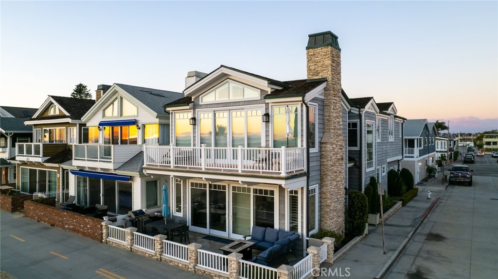 218 E Oceanfront is not just an exceptional beach front home, it's the epitome of the quintessential Newport Beach lifestyle. Imagine waking up every morning to uninterrupted panoramic views of the coastline, the soothing calming sound of waves crashing on the beach, and the scent of salt in the air. It is just a short walk or quick bike ride to various local dining establishments, specialty coffee houses and so much more. This sunny corner lot is situated on the boardwalk close to the famous Balboa pier. Do you love walking along the shore? Something to note, is the strategically placed walkway for ease across the sand taking you conveniently halfway to the magnificent Pacific Ocean. Pride of ownership is abound with the highly desirable curb appeal you have always dreamed of. Upon entering this timeless stunning home, you will be not only be surprised by the remarkable volume and meticulously finished details but you are sure to be impressed with the unsurpassed quality of craftsmanship. The open layout is ideal for entertaining with a full bar off of the kitchen, high ceilings both upstairs and downstairs, nine foot doorways, an abundance of natural light due to only one neighbor, and endless views. All three bedroom suites are upstairs with their own designated bathrooms. The spacious and lavish primary suite features a king size four poster canopy bed, a fireplace, and a large balcony to enjoy the 180 degree views of the coastline and breathtaking Catalina sunsets. Of the additional suites, one is equipped with a set of twin beds and the other with a queen size bed. There is also a large loft for a fourth sleeping area or an additional family room with a king sized pull out sofa and a built in desk area if you want to work from home. There is an immaculately finished two car attached garage that is suitable for SUVs. The AC system is brand new as well as recent upgrades including fresh paint, new flooring, recessed lighting, and more. This wonderful luxury beach house is also available for lease - turnkey, furnished and fully equipped. Whether you are looking for a rare pristine beachfront investment that is currently generating great income or your own exquisite trophy beach home, 218 E Oceanfront is the one.