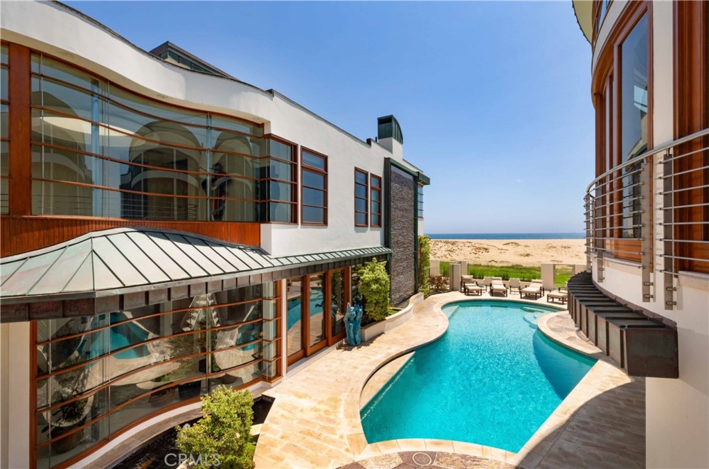 Located on the sand in Peninsula Point - Newport Beach's most sought after oceanfront location - this contemporary oceanfront compound rests on a double lot and includes a detached guest house and swimming pool. With no boardwalk in front, this property enjoys a very desirable level of privacy. Designed by architect Martin Kollin, the home is light, open, and captures expansive views of the beach, ocean, Catalina Island and sunsets. Limestone floors, blond woods, and walls of curved glass create a relaxed ambiance. The property includes a six bedroom, six and one-half bath main residence, as well as a two bedroom, three bath guest house. The master suite occupies the entire seaward facing second floor of the main residence. It is spacious, private and includes a private view terrace. The pool is situated between the two structures and is complemented by a spa, serving bar, and cabana. There is an acrylic window in the side of the pool that looks through a massive specimen fish tank into the subterranean media room. This artfully designed pool has been featured in several design publications and shows. There is four-car parking in two garages, with additional off-street parking. Come see the best of the Newport Beach oceanfront.