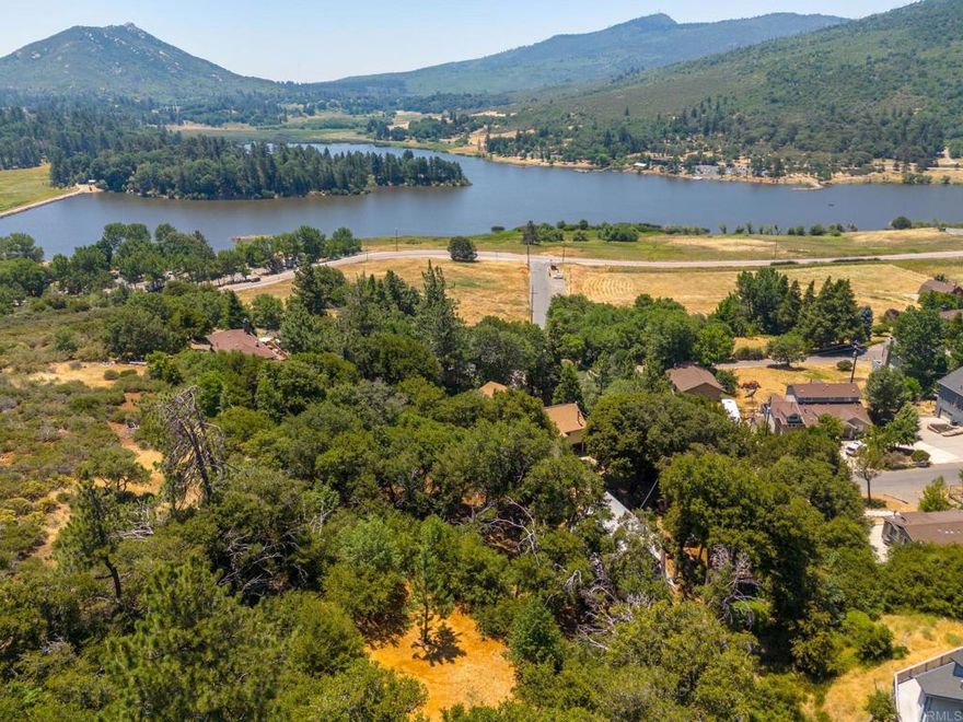 Discover your perfect getaway just minutes from Downtown Julian’s charming shops, historic attractions, and restaurants. Nestled within the Cleveland National Forest, this property is an idyllic retreat with stunning views of Lake Cuyamaca. It consists of two APNs merged by the current owner and includes the original septic system (condition unknown). The lot has been recently surveyed, cleaned, and cleared—ready for your dream home. With main access on Natchez Trail and secondary access on Papago Trail, the property offers both convenience and privacy. Water is already available; only a meter is needed to complete service. The seller has continued paying the water bill, ensuring eligibility without reconnection fees for future buyers. Just a short walk to Lake Cuyamaca State Park, where fishing, hiking, and camping await.