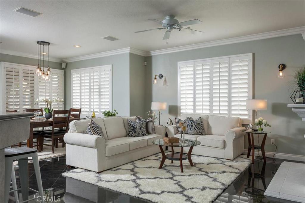 AWAY FROM IT ALL, BUT CLOSE TO EVERYTHING… That may be the perfect oxymoron to describe the location of this trendy, carriage house, condo in Sienna Ridge. Surrounded by the Saddleback Mountains, you are close to hiking trails and open areas, but still close to shopping, restaurants, toll roads, and community activities. The floor plan is brilliant with both bedrooms being on opposite sides of the home. The kitchen opens to a spacious living area and separate dining area. The upgrades in this home include plantation shutters throughout, granite flooring in main living area, granite counters, and designer paint. Built in office in one bedroom and walk in closet with built in organizer in master bedroom. The kitchen offers extensive storage and pantry area. Laundry room is inside and is made for a full size washer/dryer. The dining area opens to the oversized patio balcony. The two car garage houses lots of storage and a built in office.
