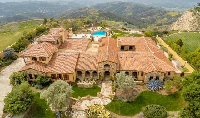 A truly AMAZING authentic Tuscan/Mediterranean Masterpiece! Custom built and designed with the highest level of quality imaginable! Behind the second gates of 24 hour guard gated The Oaks, is this one of a kind, approximately 11,000 square foot showplace. Set on a magnificent lot and boasting unobstructed views, this home and property provides RARE complete PRIVACY! The majority of living will be single level. The second story provides a secondary bedroom suite & large studio/potential gym! Other features include a state of the art home theater, bonus/game room, temp controlled wine cellar, library, and an extraordinary open family room/great room adjacent to the double island gourmet kitchen. In addition, the property boasts a detached pool/guest house, and an impressive custom covered loggia with fireplace and heated patio floors! Interior appointments include custom soaring wood beamed ceilings, stone accents, sliding pocket doors that provide indoor/outdoor living, beautiful wood & stone flooring & much more. The grounds are second to none! Amazing pool, fountains, outdoor kitchen, gardens and massive manicured lawns, all set to take advantage of the magnificent vistas! Words cannot capture the EXTRAORDINARY detail and character! This one is special!