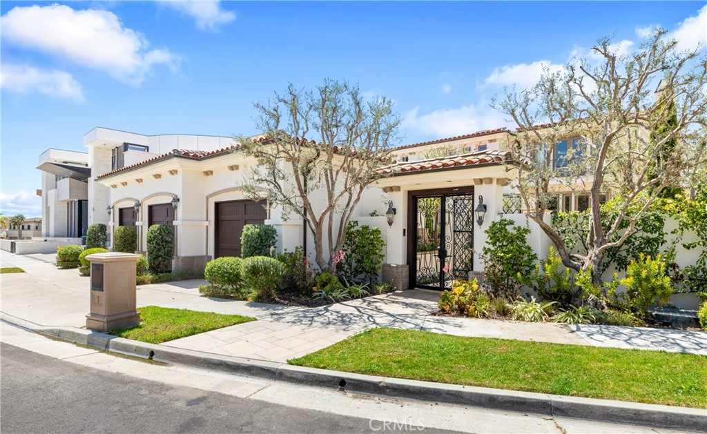 Experience the epitome of coastal luxury at this stunning home atop Spyglass Hill in Corona del Mar, where every detail is designed to capture breathtaking views of the Pacific Ocean, Newport Harbor, Catalina Island, and the city’s iconic landmarks. Perched on a tranquil cul-de-sac, this custom-built residence is as much a retreat as it is a showpiece, offering a perfect setting for both lavish entertaining and quiet relaxation. Upon entering through a gated courtyard, you’re welcomed by a custom glass and wrought-iron door that opens into a grand foyer with soaring ceilings and a sweeping staircase. The formal dining room, enhanced by a fireplace and French doors that open to the courtyard, effortlessly blends indoor and outdoor spaces, making it ideal for hosting elegant dinners or casual get-togethers. The living room, framed by expansive windows and a fireplace, provides a perfect vantage point for enjoying the home’s phenomenal views. Step outside to the backyard, where an in-ground spa invites you to unwind while taking in the serene coastal sunsets The ocean-view family room is equally inviting, complete with a walk-in wet bar, fireplace, and built-in entertainment center, making it an ideal spot for movie nights or family gatherings. This impressive home spans approximately 5,419 square feet and includes an office with custom built-ins, a wine cellar, and a gourmet chef’s kitchen. The kitchen, equipped with a central island, two sinks, Thermador double wall oven, Sub-Zero refrigerator, Viking cooktop, and dual Miele dishwashers, is a culinary dream. The home offers four ensuite bedrooms and six baths, including a main-level guest suite and a luxurious second-floor primary suite. The primary suite is a private oasis with its own fireplace, walk-in closet, ocean-view tub, and large shower. A versatile sitting area within the suite features a dumbwaiter, wet bar, and sweeping ocean and city-light views, perfect for relaxing at the end of the day or additional workspace. Additional features include an elevator, a three-car garage, and meticulously landscaped grounds. This exceptional property is conveniently located near award-winning schools, the upscale shopping and dining of Fashion Island, Corona del Mar’s pristine beaches, renowned golf courses, and the scenic hiking trails of Buck Gully Reserve. This home offers not just a place to live, but a lifestyle defined by elegance, comfort, and stunning coastal beauty.