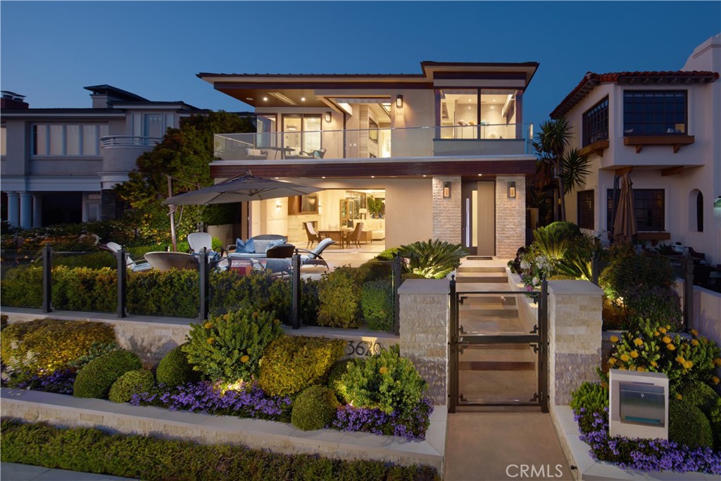 Coastal luxury living is yours to relish in the heart of Corona del Mar. Designed to capture unimpeded views of the Pacific Ocean, coastline, Catalina Island, and Newport Harbor, this soft-contemporary four-bedroom, six-and-one-half-bathroom estate offers a truly momentous lifestyle. High-end wall treatments, natural stone and wood veneers, stone flooring, and wood-framed interior doors convey a sense of extravagant drama while walls of pocket glass doors create a fluid transition between indoors and out. Open-air entertainment areas consist of an expansive ocean-view front terrace with meticulous landscaping and a private courtyard with a pool, spa, living wall, and built-in BBQ with vent hood. Inside, mesmerizing water vistas complement a fabulous great room before a linear fireplace, and a dining room with a glass-enclosed and temperature-controlled wine room. Indulge in the sophisticated kitchen that is as practical as it is refined with cleverly integrated Gaggenau appliances, plentiful storage behind handleless cabinetry, and a stone waterfall-edge island. Completing the main level is an ensuite bedroom and guest half-bath. Descend to the subterranean level where a massive lounge, game room, wet bar, dry sauna, swanky theater room, and full bath make for the ultimate entertainment venue. Primed to capitalize on the stunning coastal views, the lavish owner's suite accommodates a private deck, fireplace, sitting area, two separate baths, and a glamourous showroom-style walk-in closet. Furthering the allure of the residence is an ocean-view rooftop deck with built-in BBQ, oversized garage fitting up to 6 cars, elevator servicing all three floors, whole-house audio, a central vacuum system, smart lighting, and laundry room with dog-grooming basin. Set just moments away are Corona del Mar’s village shops, restaurants, Fashion Island, Lido Marina Village, and award-winning schools.