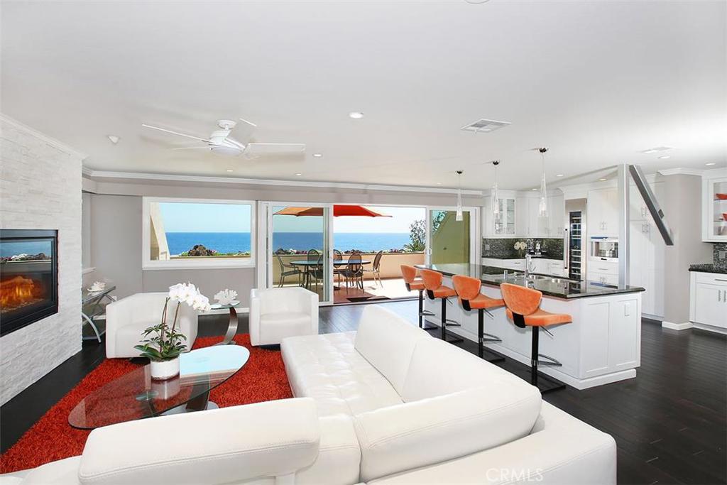 Super hip "almost oceanfront" ocean view one level condo! Just over 2000 sqft with an over 55 foot south facing balcony running the entire length of the unit to enjoy unobstructed ocean views from Dana Point to Catalina. Private Master bedroom features beautiful ocean view bath, large walk-in closet and direct access to the Jacuzzi Spa to enjoy the sunsets over the Pacific Ocean. Private serene 2nd bedroom with private patio and en suite bath. 2 BED, 2 1/2 Bath completely remodeled in 2014 to create a large open great room. Other features include oversized newly remodeled designer chef's kitchen. Additional highlights include fireplace, Q-Motion Solar Shades all windows throughout the unit electric powered from hand held remote. This highly sought after single level condominium has three parking spaces to include a single car carport on PCH side and no steps to home, making this a unit completely accessible without the use of any stairs. Additional oversized single car garage and driveway located on Cliff Dr side of property. Just completed building exterior remodel all prepaid by owners so no future assessment. HOA's only $375/mo. Come live the dream in this amazing home located in one of the most desirable locations in Laguna Beach!