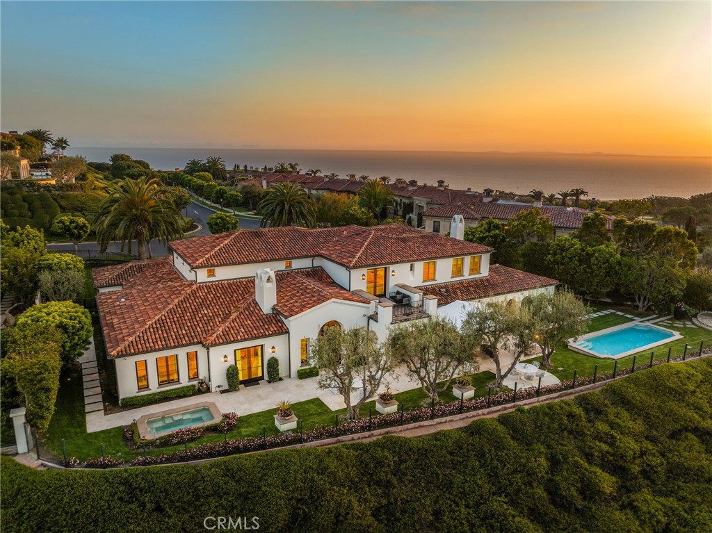 Nestled in the highly sought-after and exclusive Pelican Crest community of Newport Coast, 23 Skyridge offers an unparalleled living experience. This custom-built Mediterranean estate is a true masterpiece, blending timeless architecture with sophisticated transitional design. Situated on an expansive 22,486 (+/-) square foot lot, this home spans 7,800 (+/-) square feet and is perfectly positioned to capture breathtaking, panoramic views. From the sparkling city lights to the stunning canyons, the vistas here are truly spectacular. At the heart of the home lies a chef-inspired kitchen with Viking appliances, Calcutta de Oro countertops, and custom cabinetry, flowing effortlessly into the expansive family room and bar area—perfect for both intimate gatherings and grand-scale entertaining. Throughout the estate, you'll find wide-plank European oak and tile floors, Italian fixtures, designer lighting, and exquisite tile work, adding to the home’s sophistication and elegance. The estate features 5 opulent bedrooms, including a main floor primary suite providing ultimate privacy. With 6 luxurious bathrooms, every space is designed to offer the finest finishes and comfort. The main level includes a tranquil primary suite retreat with a separate gym, a spacious guest suite, and a private office, all designed for the utmost in luxury and convenience. Step outside to a resort-style backyard featuring a heated pool, spa, firepit, and lush landscaping, all surrounded by glass wall fencing to maximize the stunning views and offering an ideal space for alfresco dining and entertaining. The expansive covered veranda and built-in BBQ and bar serving area to ensure every outdoor occasion is an elevated event. With recent upgrades including new appliances, fresh exterior paint, and meticulous attention to detail throughout, 23 Skyridge stands as a rare opportunity to own a piece of Newport Coast’s most coveted real estate. Pelican Crest is known for its exclusivity and luxury, and this estate embodies everything that makes this neighborhood truly exceptional and worthy of its reputation.