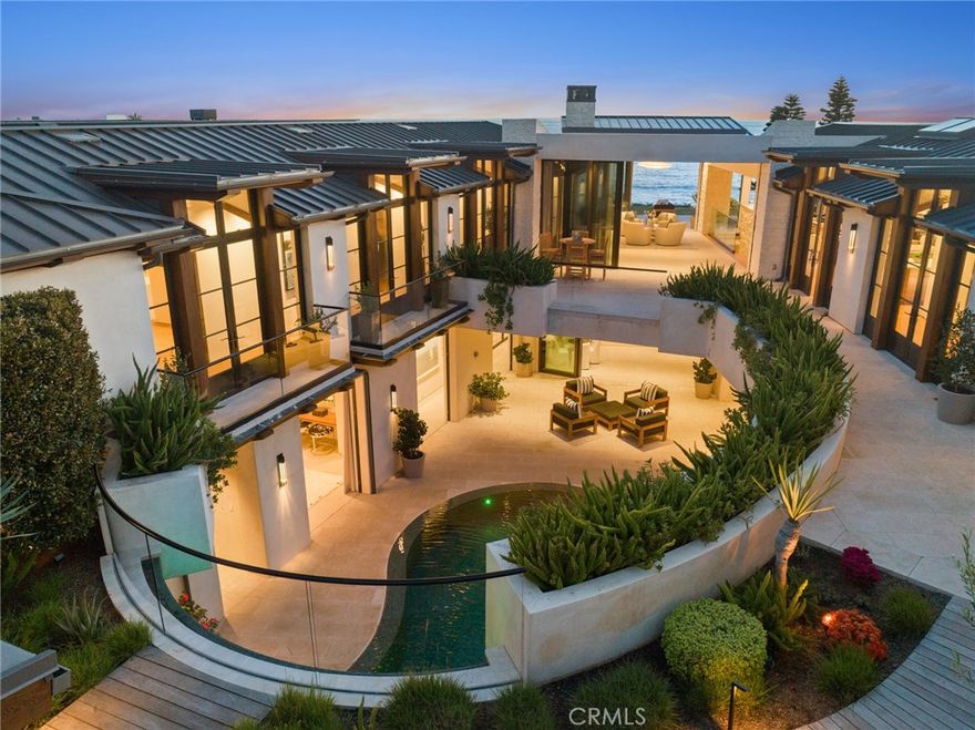 Located in the highly exclusive Cameo Shores neighborhood, this 7,000 square foot architectural masterpiece was designed to impress. The jaw-dropping panoramic Pacific Ocean views throughout are evident as you enter through the  private gate. Here you will find yourself in a personal oasis filled with lush greenery and beautiful scenery. The coastal-contemporary design of wide open spaces, soaring beamed ceilings, and walls of glass perfectly complement the natural environment and immaculate grounds. On the main level you will find an inspiring chef’s kitchen, a stunning master suite, additional living quarters and an office. At the center of the home, a sparkling infinity pool is accented by a 29-foot waterfall and surrounded by a heated loggia. The lower level of the residence offers an additional living area and wine cellar, gym with a built-in sauna, private theater equipped with a full kitchen and bar, and bedroom wing. Perched cliffside, enjoy the sound of the crashing waves and mesmerizing sunsets from the backyard, complete with a built-in BBQ, cozy firepit, and in-ground spa. Residents of this coveted neighborhood can also enjoy direct beach access, and close proximity to renowned restaurants and world class shopping. SOLD FURNISHED