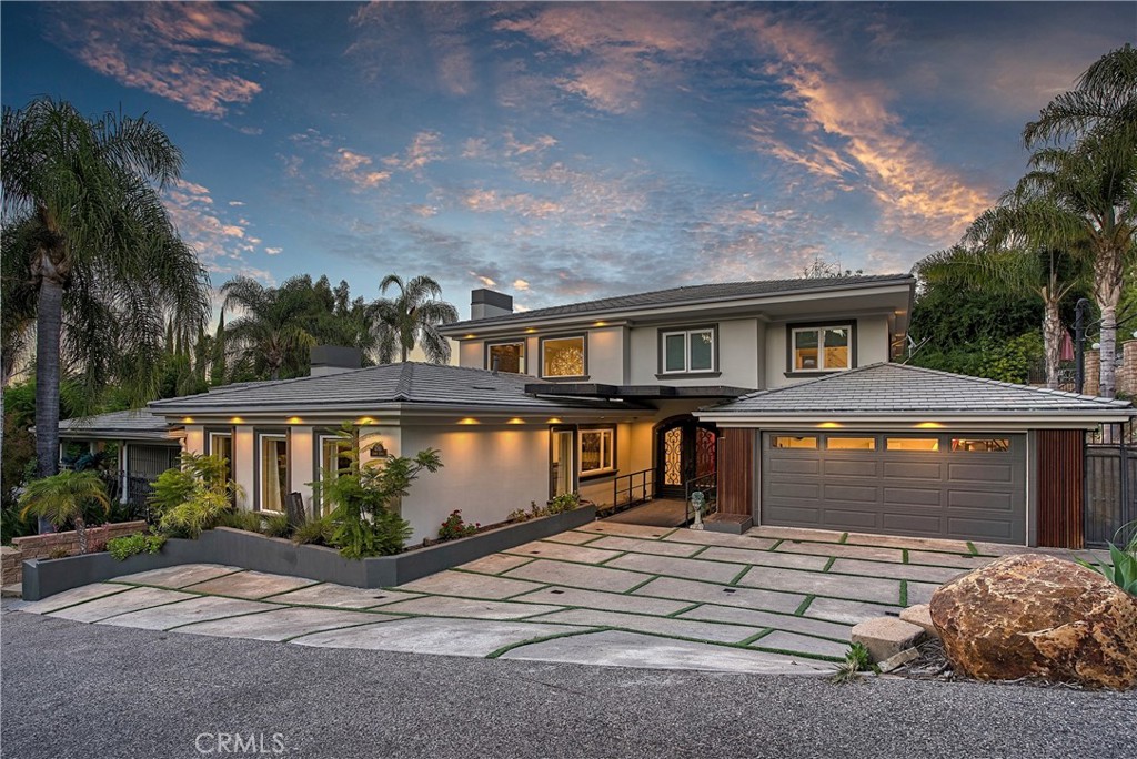 Stunning home, south of the blvd in highly coveted Tarzana is now listed for sale, and available for viewing. Sitting on nearly half an acre, this home has nearly every accommodation you could ask for, including EV charger! The main house has 4 bedrooms and 5.5 bathrooms, 4,521 sqft of luxury living. The chef's kitchen includes an oversized island with stainless steel appliances, warming drawer, walk-in pantry, custom cabinetry and so much more! The primary suite includes a Japanese soaking tub and separate steam shower with heated floors for that authentic spa experience, including His and Her walk-in closets. A lower level gated area is perfect for RV parking, garage or sports court. This property includes a detached 2 bed, 1 bath 1,142 sqft guest house that can be used for guests or a state-of-the-art recording studio, office or as a rental property. The backyard is designed in a grand resort style. Palatial salt water pool, heating, misting, koi pond, sound system and TV's throughout... built as a home with entertaining in mind! Every accommodation you could ask for.