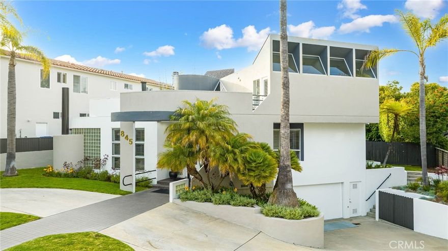 Completely custom Pat Killen design on a double lot (10,000 feet) in the prestigious Hill Section of Manhattan Beach. Killen is often considered the architect who "established Modernism as a visible architectural motif on the western edge of Los Angeles” and his studio 9one2 won several AIA awards for homes he designed. This sophisticated contemporary home has over 4300 feet of interior living space with windows everywhere for optimal light and vistas to the mature landscaping outside. The main entry level has wonderfully designed separate spaces for living, dining, lounging, reading, and a spacious office or bedroom. The kitchen is large and open with wrap around peninsula great for entertaining. There is also a private powder room. In the heart of the home is a circular staircase with glass and open space which further illuminates the floor and the level below. Beyond the multiple sets of north-facing glass doors is the incredible backyard complete with an eating area, lounging space, a sparkling pool and spa, and a grassy lawn for kids or pets to play, all surrounded by large mature trees which provide beauty and privacy. The home includes six amply bedrooms and four and one-half bathrooms, with four of the bedrooms (including the primary) on the top floor, one on the main level, and one below. The top-floor rooms have streaming sunlight and ample closet space, each with a small balcony. The primary suite has his and hers closets and a fireplace. Another fireplace with black stone and gold accents acts like art in the family room adjacent to a cozy bar that leads to the yard behind. The lower level includes a bedroom, bathroom, laundry, storage rooms/closets, and access to the oversized two-car garage.