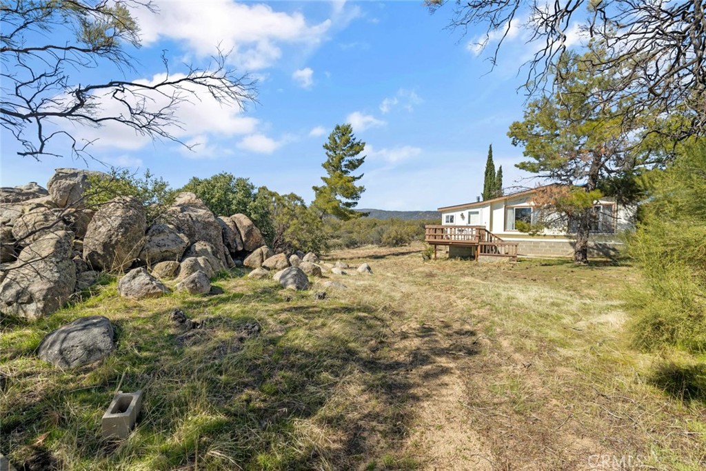 Incredible opportunity to own this manufactured home with 2 bedrooms and 2 baths with 1,440 square feet on 2.23 acres of land! Gorgeous views of the serene Anza Valley can be taken in from both inside and outside the home. Enjoy the tranquil surroundings from the spacious deck where you can relax from sunrise to sunset with beautiful views of the valley and mountains. In addition to the home, this sprawling property offers a 2-car garage with concrete slab, an unpaved garage for a tractor and other toys attached to a large shed or workshop, and a chicken coop. The dual-pane windows abound in this home and along with the vaulted ceilings in the living area bring in an abundance of natural light. A wood-burning stove adds warmth and beauty to the space. Huge primary bedroom suite features a large walk-in closet. The primary bath offers a separate shower and soaking tub and dual sinks on the large vanity. The second bedroom is also spacious and bright. The second bath has a large step-in shower. The spacious kitchen offers seating at the counter and even includes the refrigerator. The large laundry room includes the side-by-side washer and dryer and plenty of storage space. A private well and owned propane tank add to the many desirable features. A very comfortable home with peaceful surroundings and beautiful views make this property a nature lover's dream!