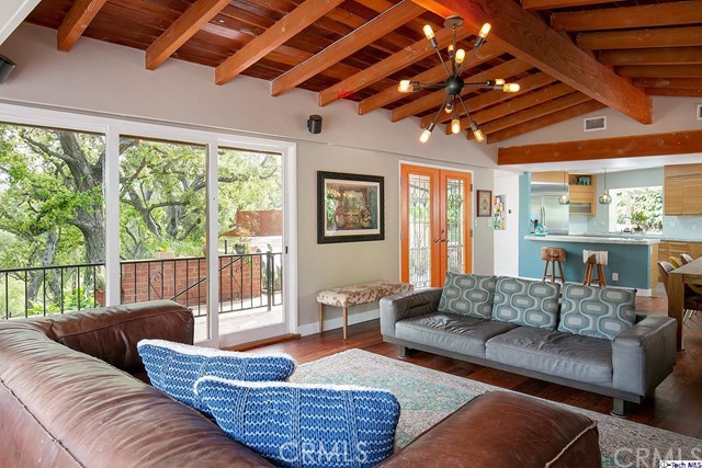 Mid-Century sited at top of private drive surrounded by nature and a feeling of seclusion. Large floor to ceiling sliders throughout allow panoramic views from almost any vantage point and fill the home with natural light. Living Room with original redwood beam vaulted ceiling and sandstone floating hearth is open concept to dining and kitchen. Kitchen is a chef's dream: exotic Calcite counter tops, Bamboo cabinets, Porcelanosa® flooring and stainless steel appliances. An expansive patio offers a perfect retreat or a dramatic backdrop for al fresco entertaining. All 3 bedrooms are off the center hall. Master with glass slider provides tranquil vistas and personal access to the outdoors, ensuite bath with Carrera marble over-sized shower and Axor® water conserving rain-head, custom walnut vanity w/ Carrera marble and a custom walk-in closet. This special Mid-Century, blending subtle sophistication and California living, awaits you