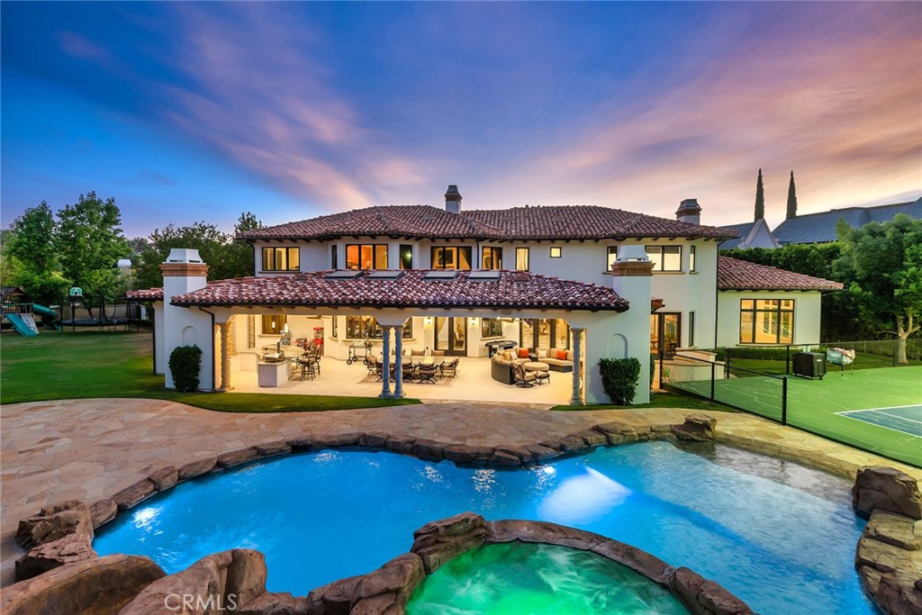 Epic Mediterranean Villa with a prime "end of cul-de-sac" location in one of Southern California's premier guard gated communities, The Estates of The Oaks. Spanning nearly 8000 square feet with an additional 1570 square foot covered outdoor living area is this timeless designed mega estate which prominently sits on over 3/4 of an acre of usable grounds! Interior features include a dramatic two story entry with sweeping iron staircase, theater/game room, temp controlled wine cellar, gym, office and much more. There are 6 bedrooms(4 up and 2 down) and 7 bathrooms. The resort quality grounds are second to none boasting a rare private tennis court with lights, custom grotto pool and spa with slide, firepit and massive manicured lawns. There is also an absolutely stellar barbecue center/outdoor kitchen & fireplace. Other amenities include a 4 car garage, gated motor court and too much more to mention. Also available for lease at $35,000/month or lease option.