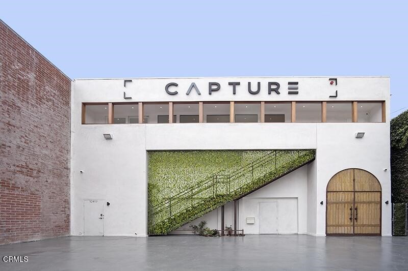 We are proud to present 12417 Ventura Ct. Capture Studios. This property is a state-of-the-art production, recording studio and event space with best-in-class amenities. This recently renovated two story boutique flex building features four restrooms, one green room, a modern kitchen, with two studios that have a maximum capacity of 93 people (Downstairs Studio Capacity: 76 & Upstairs Studio Capacity: 17). The property was recently renovated to like-new condition with high-grade finishes ideal for production, content creation, still photography, and events. Building features high speed Fiber internet throughout, this technology makes the property suitable for all kinds of content production, including metaverse content, web hosting, podcasting, and live streaming. The interior creates a white canvas for mixed media use. The property features upgraded amenities including additional soundproofing, epoxy white floors throughout, green room for talent, powerful new HVAC system, racking systems for music and lighting. The property consists of +/-3,500 square feet of LAC2 zoned land and is located on Ventura Court just off the 'hip strip' Ventura Boulevard with immediate proximity to major studios (Disney, NBC/Universal, Warner Brothers, DreamWorks, etc.). **BUYER TO VERIFY SQ FOOTAGE OF BUILDING/LOT**