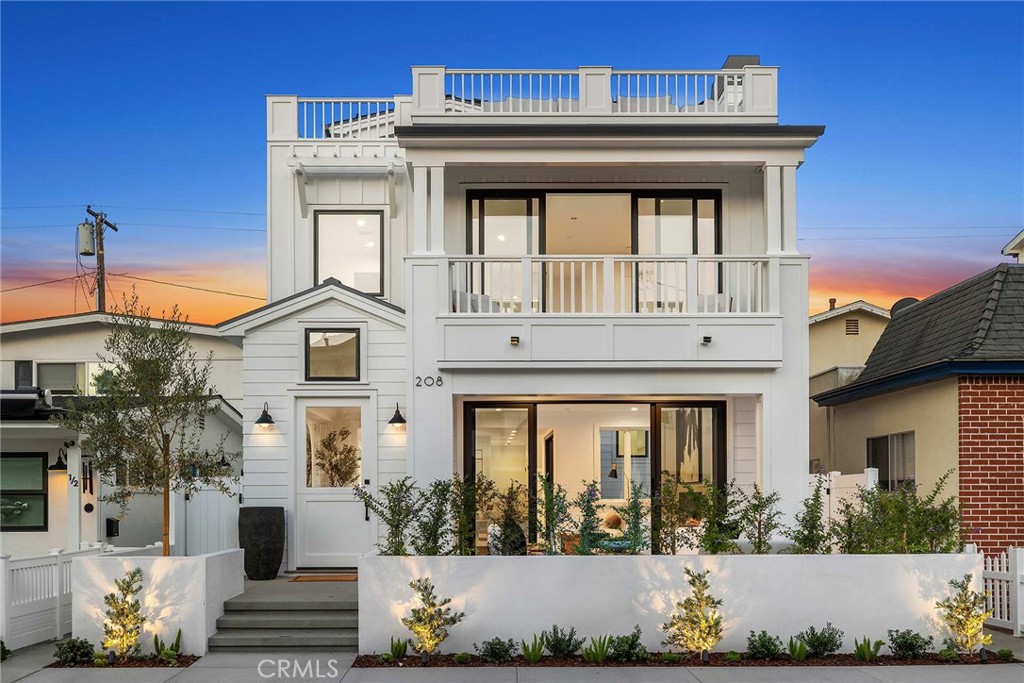 This stunning Cape Cod home, thoughtfully built by Waterpointe Custom Home Builders and designed by Ian Harrison, blends coastal luxury with timeless design in a spacious layout with an elevator connecting all three levels. Enter through a large front patio to a main living area centered around a cozy fireplace, seamlessly opening to a private courtyard with a tranquil fountain and folding doors, creating a perfect indoor-outdoor experience. The chef’s kitchen, featuring Wolf and SubZero appliances, includes a spacious island with bar seating, a large walk-in pantry, and ample room for entertaining. On the second level, the primary suite offers a retreat-like atmosphere with an incredible bathroom, an oversized walk-in closet, and a private balcony, joined by two additional guest suites, one of which is a generous JADU with its own private staircase, a bar area with a sink, refrigerator, elegant tile backsplash, and floating shelves. The rooftop deck crowns this remarkable home, with an expansive indoor area accommodating a seating area, office, or gym setup, complete with a bathroom and ample storage, alongside a covered loggia and a raised open-air seating area with stunning views of the Bay, Fashion Island, and beyond. Situated on a wide street just a few blocks from the ferry, don’t miss out on this incredible opportunity!