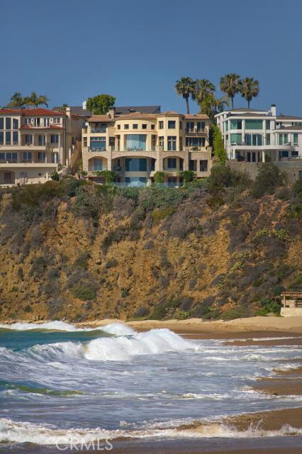 Prominently positioned on the prestigious peninsula above the golden sand of Emerald Bay’s coveted private beach, the vast Pacific Ocean sprawls out beneath you. This magnificent oceanfront estate invites you to savor boundless views stretching down the alluring California coastline and extending beyond Catalina Island. Soaring two-story ceilings, an abundance of large windows, and skylights allow natural sunlight to flood each open living space, inviting you to bask in the relaxed coastal ambiance. The open floor plan was meticulously designed with every convenience for modern living. A state-of-the-art kitchen offers designer appliances, Calcutta marble countertops, custom cabinetry and a grand kitchen island. In the master retreat, dual sets of French doors offer access to two separate private balconies overlooking the inviting waters below. Whether reading in the stately office, indulging in the media room, or hosting casual events in the family room, each space within this estate offers an intensified luxury experience. A sparkling pool and soothing spa are perched on the bluff with direct ocean exposure, providing the ultimate opportunity for taking in countless color-saturated sunsets and the twinkling city lights of Laguna Beach.