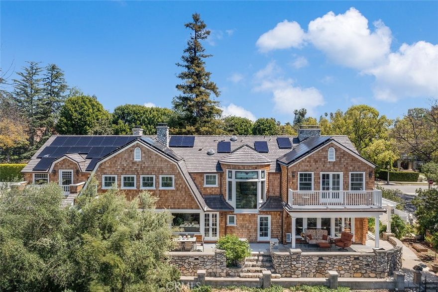 Designed by Seymour Locke in 1895, this spectacular shingled Hamptons-style home has recently undergone a complete restoration and renovation - beautifully retaining its architectural splendor while integrating all of the modern systems and amenities of the 21st century.  Located on in one of the most historic neighborhoods in southwest Pasadena and on a street that is lined with impressive architectural residences, the home sits on ¾ of an acre with expansive views of the Arroyo Seco. The first floor features a generous front porch, grand foyer with curving staircase, large formal entertaining rooms, multiple fireplaces, hardwood floors, detailed moldings, French doors leading out to various patios, a gourmet kitchen with a semi-circular, glassed-roof conservatory, two powder rooms, a ¾ bath, and a finished two-car garage with built-in storage, EV charging outlets, recessed lighting, ceiling fans, laundry area and sink. Upstairs are four spacious and light-filled bedrooms – all ensuite and with lovely views. There is also a spacious wood-paneled bonus room that can be used for a media room or home office space. The meticulous renovation befitting this grand property also includes solar panels, an all-house water softening system, 14 KW generator, and finished basement. With close proximity to many of the city’s private schools, Old Town Pasadena, and the Norton Simon Museum, this iconic Pasadena estate is ready for its close-up.