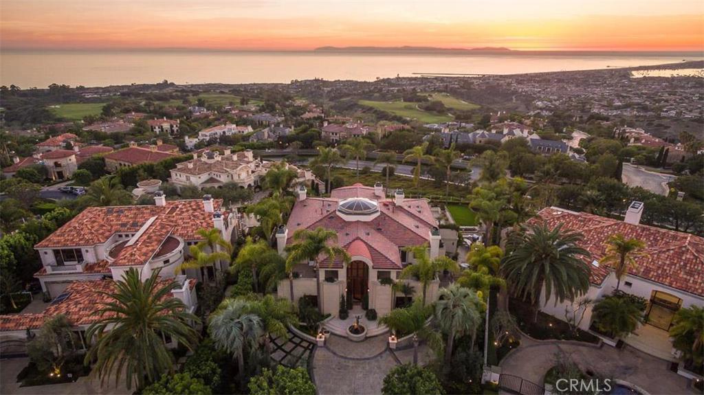 5 Sea Shell is the pinnacle of ultimate luxury coastal living with its incredible Art Deco styling and siting encompassing what could be considered the most expansive view in Pelican Hill. The level lot was sought after and claim-staked by the original owner for its complete 180 degree vistas including a clear shot of Catalina, Palos Verdes and the Los Angeles skyline. Boasting premium and designer touches throughout, this over 10,000 sqft villa estate blends grand-scale entertaining with private luxury. Enter the home through the soaring entry way with water features both inside and out and enjoy a main level floor plan fit for gatherings with numerous sets of french doors leading out to the flat patio terrace which hosts a knife-edge pool with adjacent spa, outdoor kitchen and multiple sitting areas. Three large bedroom suites on the upper level (each with private terrace), including the master suite with fireplace, wet bar, adjacent study and terrace spaces that give way to the best view in the home. A main level bedroom suite can also act as a second master suite. Home is equipped with such spectacular features as the commercial grade elevator, wine cellar, an in-home gym outfitted with massage room, wet bar & sauna and a subterranean 10 car garage.