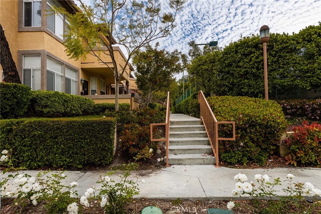 Location!!Location!!Location!! You'd be hard pressed to find a better location within the gated Resort Style Living "Tuscany Condo Complex". Incredible opportunity for first-time buyers to live in the wonderful hillside community of Foothill Ranch! This turnkey upper level unit offers two spacious master suites with approximately 1060 square feet of comfortable living space for everyone. The open floor plan boasts vaulted ceilings in the large living room with a cozy fireplace and large window overlooking the huge patio, plus a laundry closet for a full-sized washer & dryer. You'll love the remodeled kitchen with stainless steel appliances, beautiful cabinetry, and stylish countertops. Enjoy tranquility and privacy with mountain and greenery views overlooking the tennis courts. While offering a shared garage located directly under the unit with a storage locker. Tuscany is rich in amenities with two separate pools, clubhouse, fitness center, tennis court & putting green.